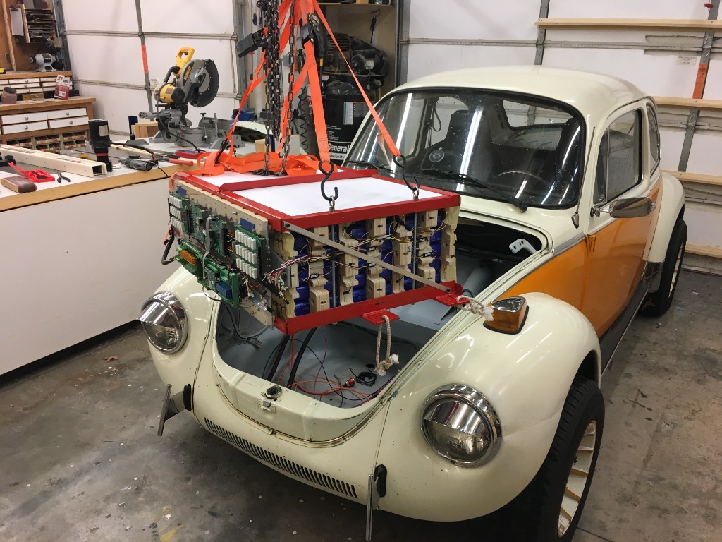 1977 VW Super Beetle electric conversion with battery pack being lowered into the front compartment